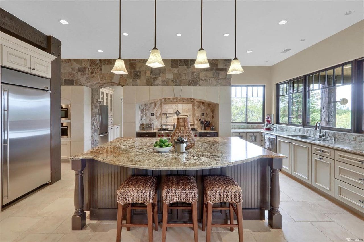 A large kitchen with a center island and a bunch of lights