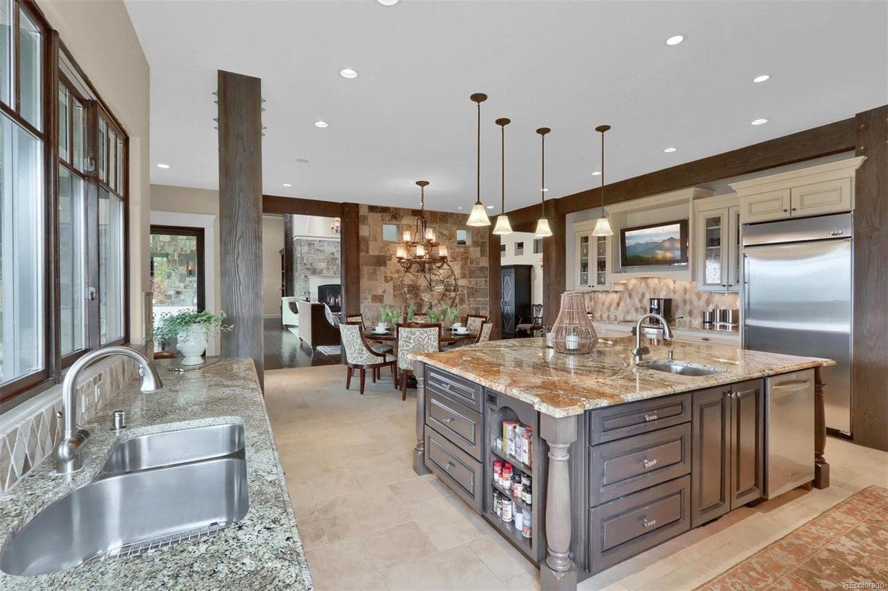 A large kitchen with granite counter tops and island.