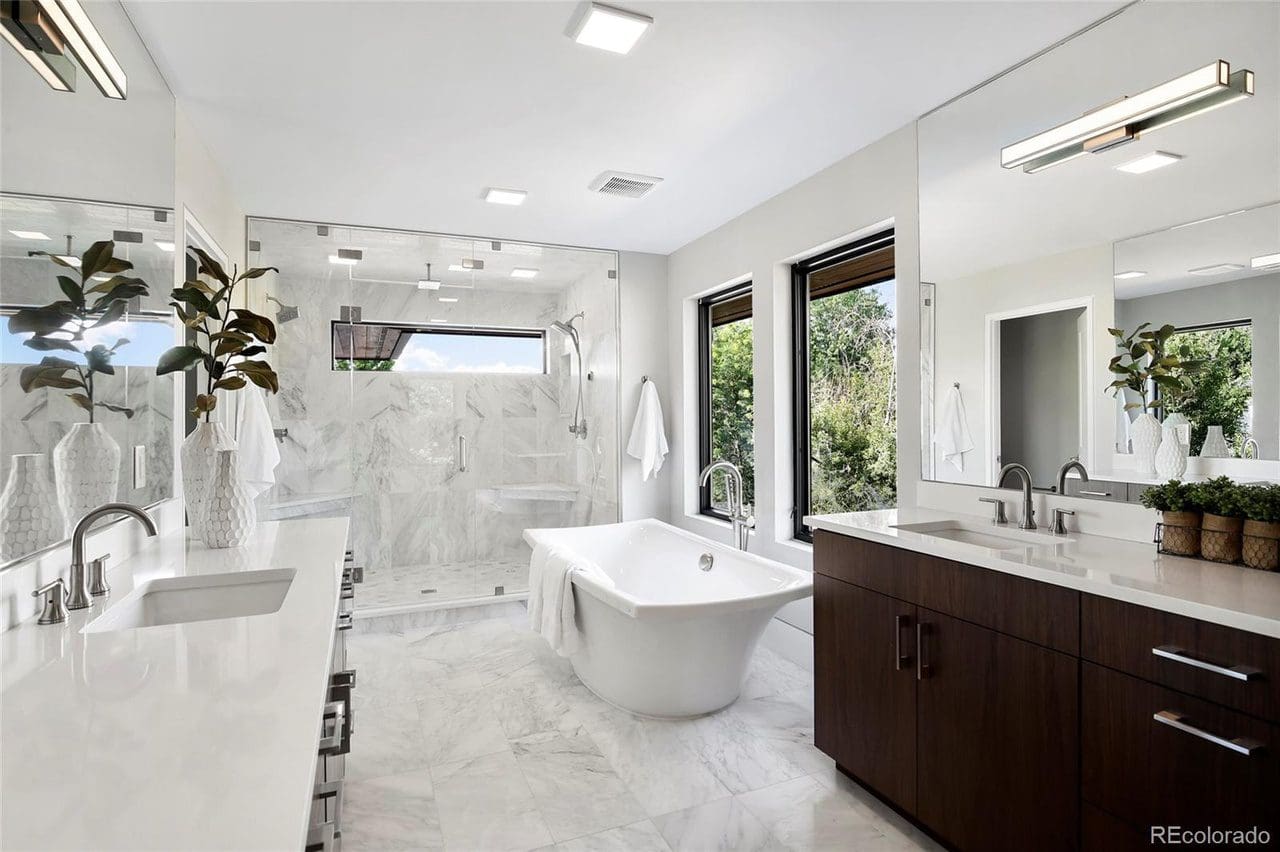 white bathroom with sink and counter with large mirror