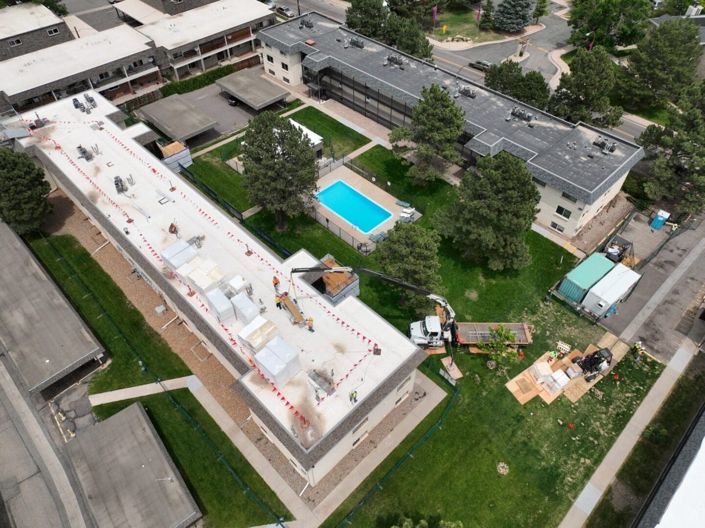 aerial view of building construction with pool