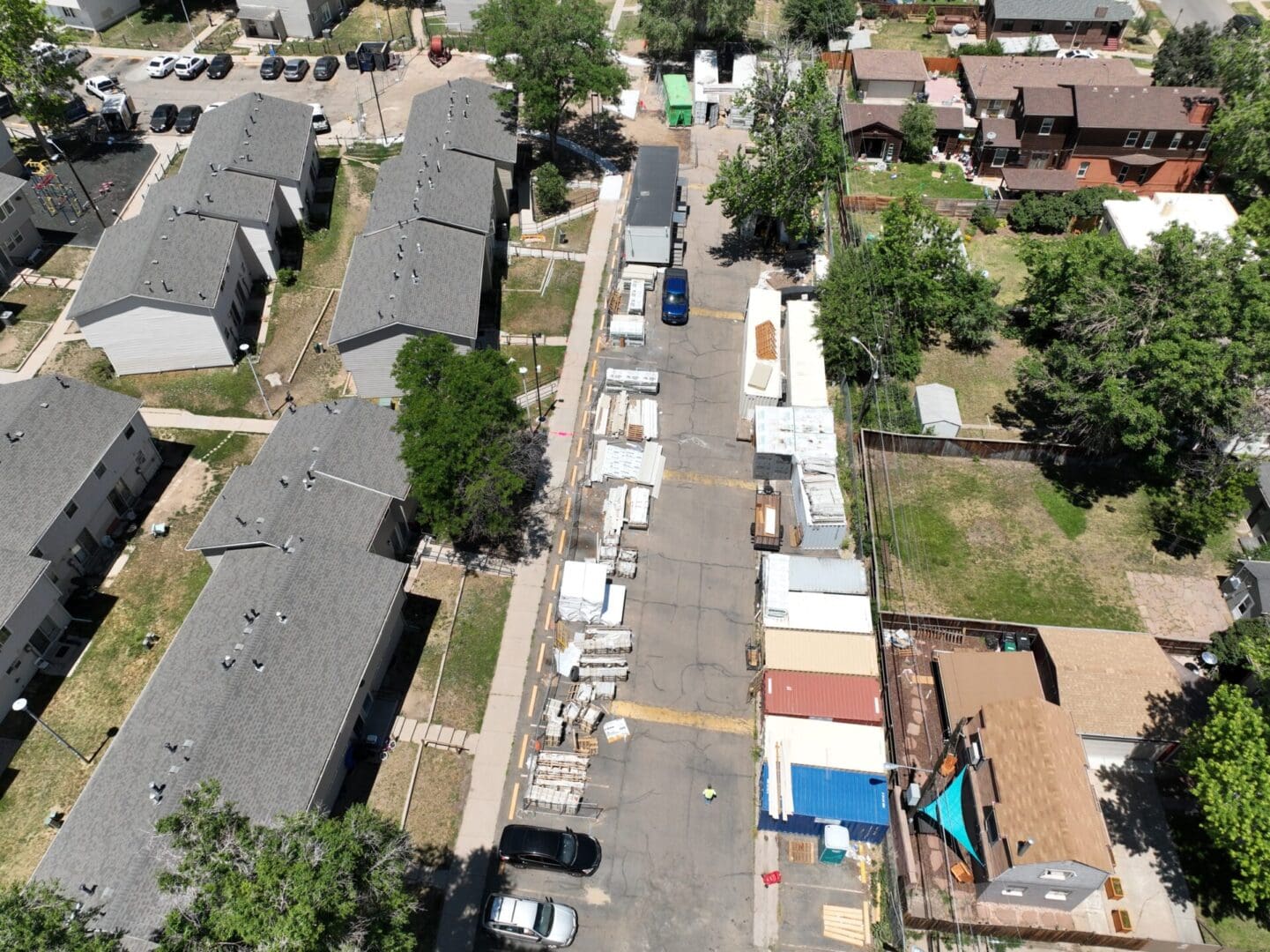 aerial view of subdivision with houses and cars